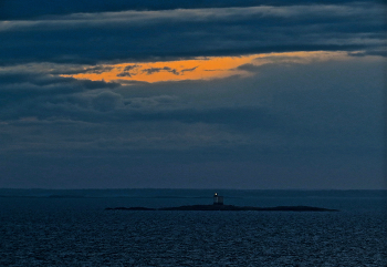 Островок с «моргалкой» / Небольшой автоматический маяк, дающий свет вспышками, как бы мигая (моргая, — ВК). 
Морской словарь. https://dic.academic.ru/dic.nsf/sea/5190/МИГАЛКА?ysclid=ln59l0xdz358721521

Ботнический залив. Шведские шхеры.