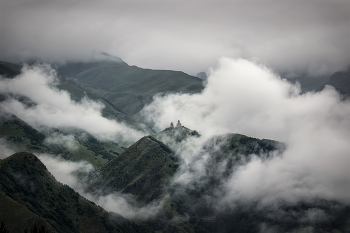 Gergeti Trinity Church In Clouds / A gloomy day in Kazbegi. Clouds envelop Gergeti Trinity Church