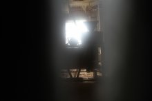 Мельница / фотография сделана через щель в массивной двери старинной мельницы