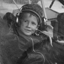 young pilot / kid siting in a small sport plane. i was made this portrait in a moment, love it for it's emotions and child openness