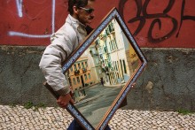 Streets of Lisbon / Just an occasional shot of man carrying a mirror near flea market in Lisbon.