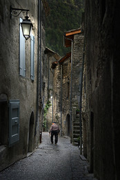 Evening walk / An old man making his evening walk in the narrow streets of Chatillon-en-Diois / France.