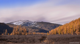 Бурхан Халдун / Genghis Khan (also known as Chinggis Khan) lost his battle against the Merkit (one of the major tribal confederations (khanlig) of the Mongols) and escaped death by seeking protection in the sacred precincts of the Burkhan Khaldun mountains. An old woman saved him and a few others. As mark of great reverence to the mountain, which in Mongolia is considered a highly sacred mountain of spiritual significance, and to the sun above, he offered his respects to the spirits of the mountain around him, sprayed milk into the air and sprinkled it on the earth. He removed his girdle strap, unwinding it from his outfit, and then put it around his neck. 
https://en.wikipedia.org/wiki/Burkhan_Khaldun