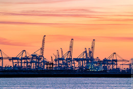 Sunset in Rotterdam port / Scenic sky view over the container terminal at Hoek van Holland, The Netherlands