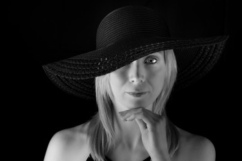 &nbsp; / Black and white portrait shot of Millie modeling a wide brimmed black hat.