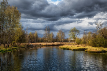 Russian spring landscape with reflections of trees in the lake. / Russian spring landscape
